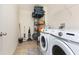 Laundry room with front loading washer/dryer and wire shelving unit for storage at 928 Cherry Tree Ln, Greenwood, IN 46143