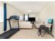 Living room with treadmill, comfortable seating, and natural light at 928 Cherry Tree Ln, Greenwood, IN 46143