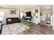 Bright living room with a large couch, entertainment center, and an open concept design at 928 Cherry Tree Ln, Greenwood, IN 46143