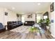 Open-concept living room with large couches, a big TV, and plenty of natural light at 928 Cherry Tree Ln, Greenwood, IN 46143
