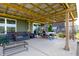 An ample pergola with a patio set, swings and coffee table for entertaining in the backyard at 928 Cherry Tree Ln, Greenwood, IN 46143
