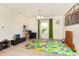 Spacious playroom area with a bright playmat, toys, and plenty of room to enjoy at 928 Cherry Tree Ln, Greenwood, IN 46143
