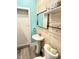 A bathroom featuring a pedestal sink, wood paneling, and a modern mirror at 929 W Roache St, Indianapolis, IN 46208