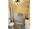 Bathroom with toilet, vanity, and shelf for storage at 929 W Roache St, Indianapolis, IN 46208