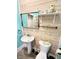 A bathroom featuring a pedestal sink, wood paneling, and a modern mirror at 929 W Roache St, Indianapolis, IN 46208