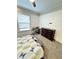 A bedroom featuring a dark wood dresser, desk, and a bright window at 929 W Roache St, Indianapolis, IN 46208