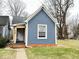 Charming single-Gathering home featuring light blue siding, crisp white trim, and a well-maintained lawn at 929 W Roache St, Indianapolis, IN 46208