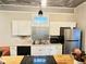 A kitchen featuring white cabinetry, stainless appliances, and a stainless steel backsplash at 929 W Roache St, Indianapolis, IN 46208