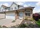 Attractive townhome with brick accents, a white front door, and professionally landscaped garden at 9404 Enclave Dr # D, Avon, IN 46123