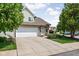 Lovely townhome featuring an attached garage, a wide driveway and mature trees at 9404 Enclave Dr # D, Avon, IN 46123