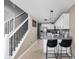 Open kitchen with white cabinets, tile backsplash, stainless steel appliances, and barstool seating at 9404 Enclave Dr # D, Avon, IN 46123