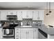 Well-equipped kitchen with modern appliances, white cabinetry, and stylish backsplash at 9404 Enclave Dr # D, Avon, IN 46123