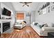 Bright living room with hardwood floors, a fireplace, and comfortable couches at 9404 Enclave Dr # D, Avon, IN 46123