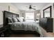 Main bedroom featuring a large bed, dresser, and fan at 9404 Enclave Dr # D, Avon, IN 46123