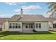 Spacious backyard featuring a lush green lawn, mature trees, and the home's exterior with large windows at 9760 Innisbrook Blvd, Carmel, IN 46032