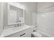 Bright bathroom showcasing a marble countertop, white vanity, and a tub with a shower, creating a clean and modern space at 9760 Innisbrook Blvd, Carmel, IN 46032