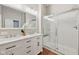 Bathroom features a double vanity, large mirror, and glass-enclosed shower at 9760 Innisbrook Blvd, Carmel, IN 46032