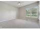 Sun-filled room with carpet and views from a large window with blinds at 9760 Innisbrook Blvd, Carmel, IN 46032
