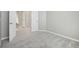 Neutral bedroom featuring plush carpeting and light walls, with an open doorway and adjacent hall visible at 9760 Innisbrook Blvd, Carmel, IN 46032