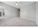 Carpeted bedroom includes a ceiling fan and natural light from a large window at 9760 Innisbrook Blvd, Carmel, IN 46032