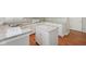 Charming kitchen includes white cabinets, granite countertops, and a central island at 9760 Innisbrook Blvd, Carmel, IN 46032