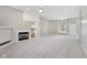 Open living room with a fireplace and seamless access to the kitchen, perfect for gatherings at 9760 Innisbrook Blvd, Carmel, IN 46032