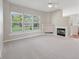 Bright living room with large windows and a fireplace, offering a cozy atmosphere at 9760 Innisbrook Blvd, Carmel, IN 46032