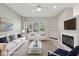 Comfortable living room featuring a fireplace, plush seating, and abundant natural light at 9760 Innisbrook Blvd, Carmel, IN 46032