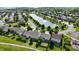 An aerial view showcasing the well-maintained neighborhood with a pond, sidewalks, and green spaces at 10773 Brighton Knoll S Pkwy, Noblesville, IN 46060
