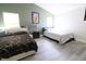 Bedroom featuring two beds with modern decor and wood-look floors at 10773 Brighton Knoll S Pkwy, Noblesville, IN 46060