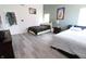 Spacious bedroom featuring two beds with modern decor and wood-look floors at 10773 Brighton Knoll S Pkwy, Noblesville, IN 46060