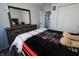 Bedroom with a large dresser and mirror, and a bed with a black and white blanket at 10773 Brighton Knoll S Pkwy, Noblesville, IN 46060