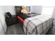 Bedroom featuring a bed with a teddy bear, dark nightstand, and wood-look floors at 10773 Brighton Knoll S Pkwy, Noblesville, IN 46060