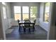 Sunlit dining area features a table with chairs, complemented by large windows and light-colored walls at 10773 Brighton Knoll S Pkwy, Noblesville, IN 46060