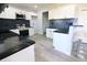 Spacious kitchen featuring white cabinets, stainless steel appliances, dark countertops, and bar seating at 10773 Brighton Knoll S Pkwy, Noblesville, IN 46060
