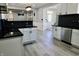 Bright kitchen boasts white cabinets, dark countertops, stainless steel appliances and updated lighting fixtures at 10773 Brighton Knoll S Pkwy, Noblesville, IN 46060