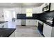 Bright kitchen with white cabinets, stainless steel appliances and dark countertops at 10773 Brighton Knoll S Pkwy, Noblesville, IN 46060