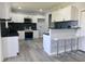 Beautiful eat-in kitchen with white cabinets, dark countertops and stainless steel appliances at 10773 Brighton Knoll S Pkwy, Noblesville, IN 46060