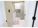 Well-lit laundry room features white cabinets, a washer and dryer, and clean tile flooring at 10773 Brighton Knoll S Pkwy, Noblesville, IN 46060