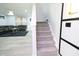 Staircase leads to a open living area with updated lighting and modern decor at 10773 Brighton Knoll S Pkwy, Noblesville, IN 46060