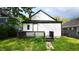 Back exterior view with a wooden porch and well-manicured lawn at 1148 N Pershing Ave, Indianapolis, IN 46222