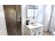 Small bathroom featuring modern sink and vanity, with hallway view to the dining and living room at 1148 N Pershing Ave, Indianapolis, IN 46222