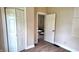 Bedroom with hardwood flooring, view to living room, and a double-doored closet at 1148 N Pershing Ave, Indianapolis, IN 46222