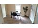 Bright dining area with wood-look floors, modern table set, and large window offering natural light at 1148 N Pershing Ave, Indianapolis, IN 46222