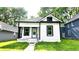 Charming bungalow with black and white trim, featuring a small front porch and walkway to the home at 1148 N Pershing Ave, Indianapolis, IN 46222