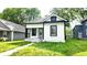 Charming bungalow with black and white trim, featuring a small front porch and walkway to the home at 1148 N Pershing Ave, Indianapolis, IN 46222