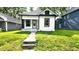 Charming bungalow with black and white trim, featuring a small front porch and walkway to the home at 1148 N Pershing Ave, Indianapolis, IN 46222