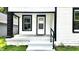 Close up of porch with view of front door, black and white trim, and dark pillars at 1148 N Pershing Ave, Indianapolis, IN 46222