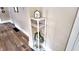 Chic hallway display shelf with faux marble finish, decorative accents, and leafy green plant adds modern flair at 1148 N Pershing Ave, Indianapolis, IN 46222