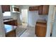Spacious kitchen with plentiful wood cabinets and countertops, offering ample storage and workspace at 1148 N Pershing Ave, Indianapolis, IN 46222